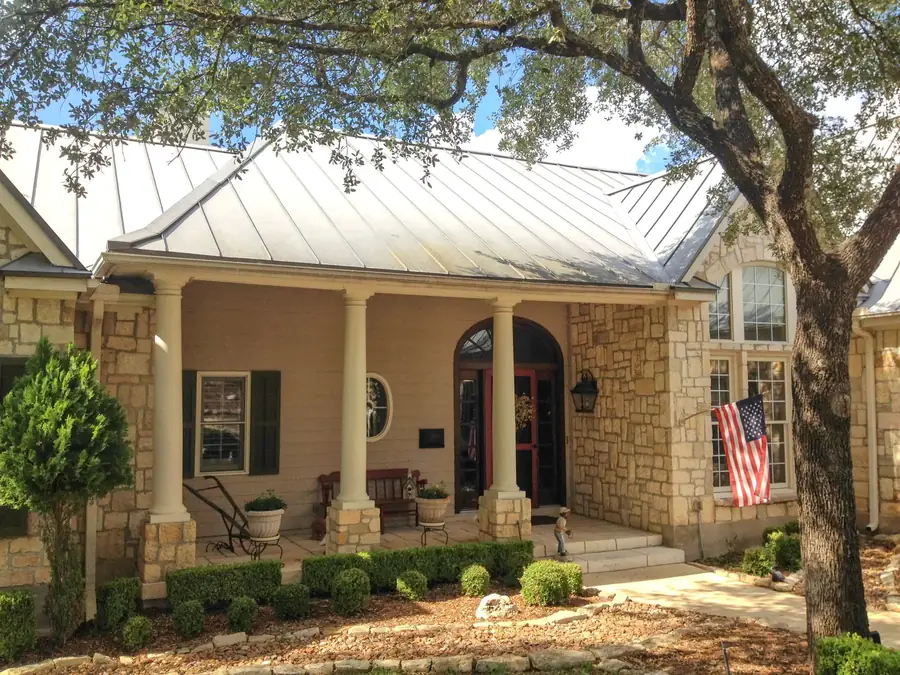 Front elevation of a house after repainting, with recoated siding, trim and entry door