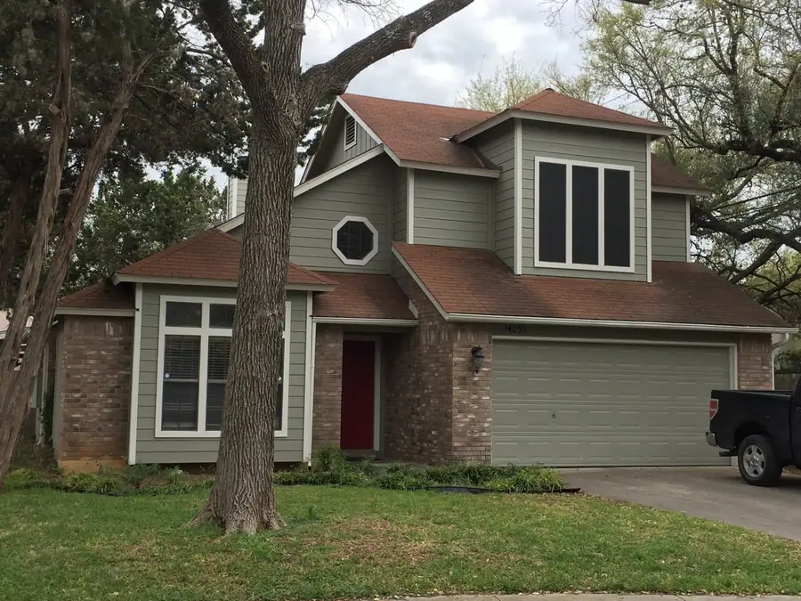 Side elevation of a house after repainting, with siding, trim and downspout recoated