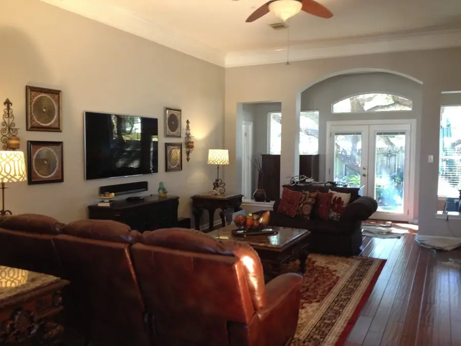Living room with repainted walls, high ceiling and arched openings in a San Antonio home