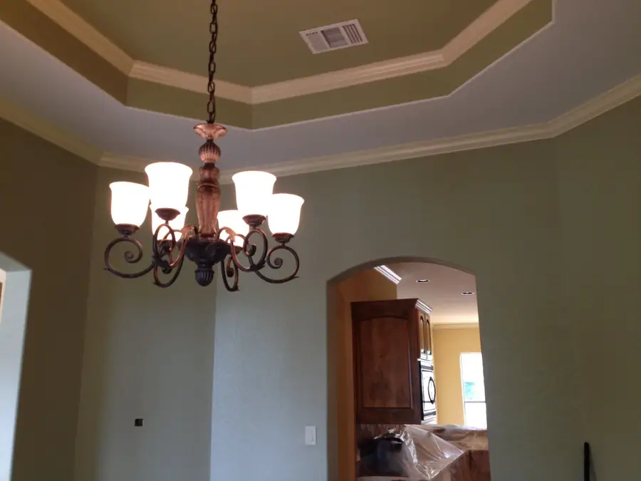 Octagonal tray ceiling painted in a soft sage tone with white crown molding